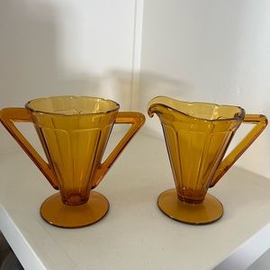 Diamond Glass Company creamer and sugar set.Pattern is “Victory” beautiful amber